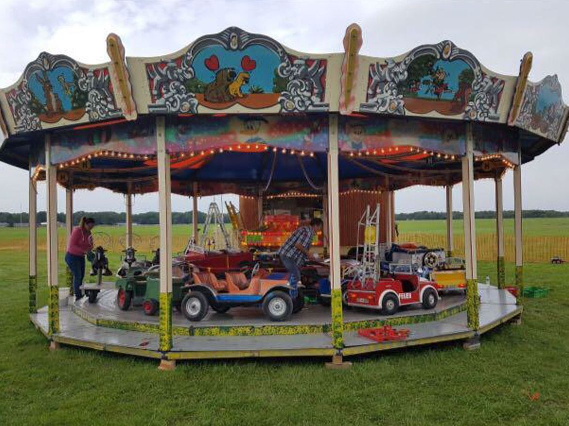 Modernes Kinderkarussell auf einer Wiese